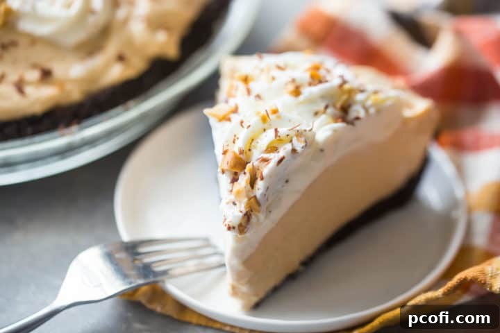 Slice of peanut butter pie on a white plate with an orange napkin.