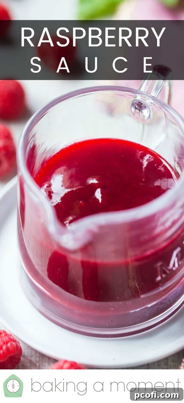 Close-up image of a glass pitcher of homemade raspberry sauce, with a text overlay above that reads "Raspberry Sauce," highlighting its vibrant color.