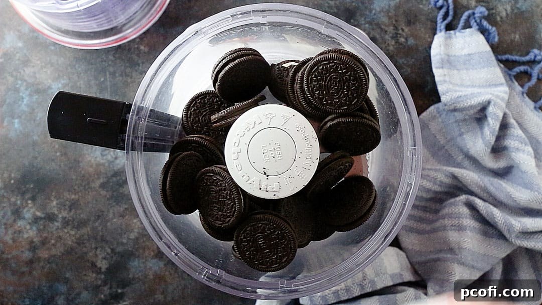 Oreo cookies in the bowl of a food processor, ready to be ground into fine crumbs for the pie crust.