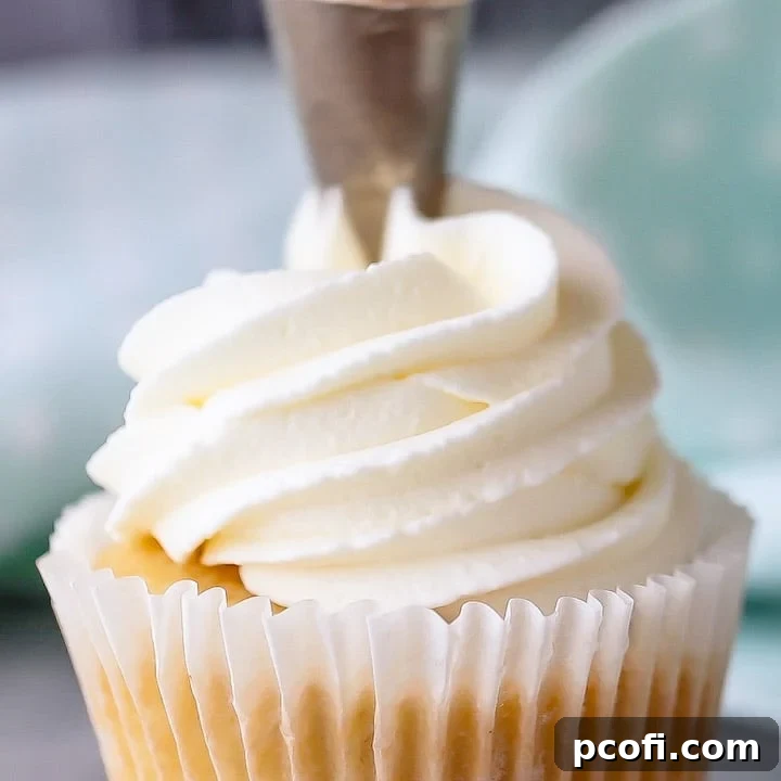 Piped whipped cream frosting on a cupcake, ready to be made ahead for cakes and cookies.