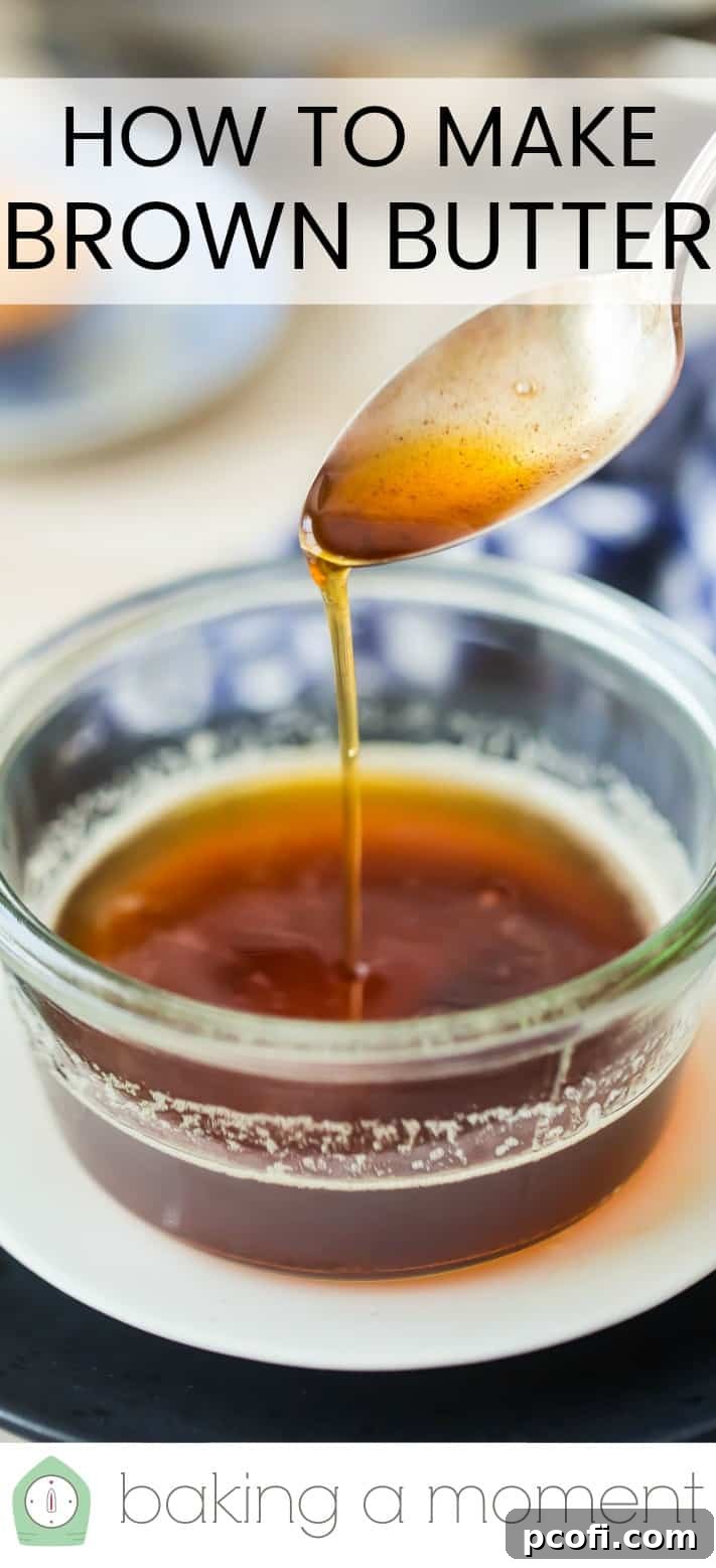 Drizzling brown butter from a silver spoon into a glass bowl.