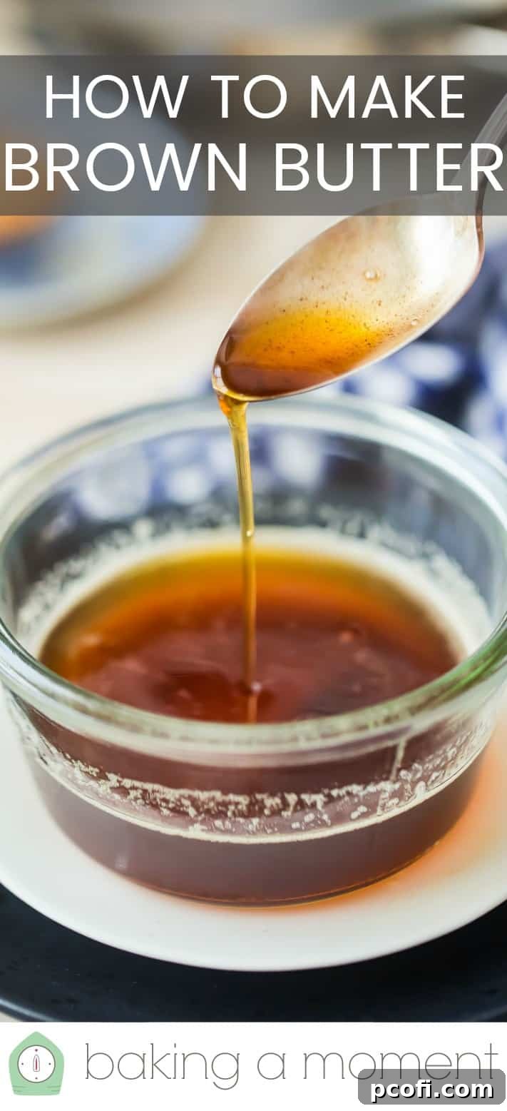Drizzling brown butter from a silver spoon into a glass bowl.