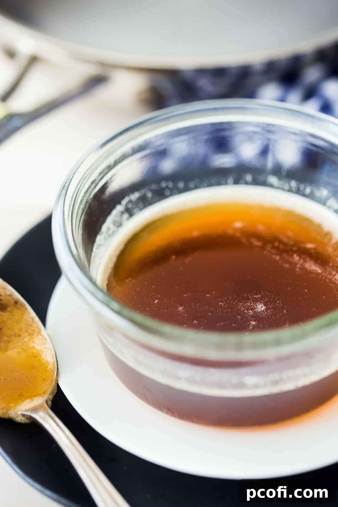 Close up image of a small glass bowl of nutty brown butter.