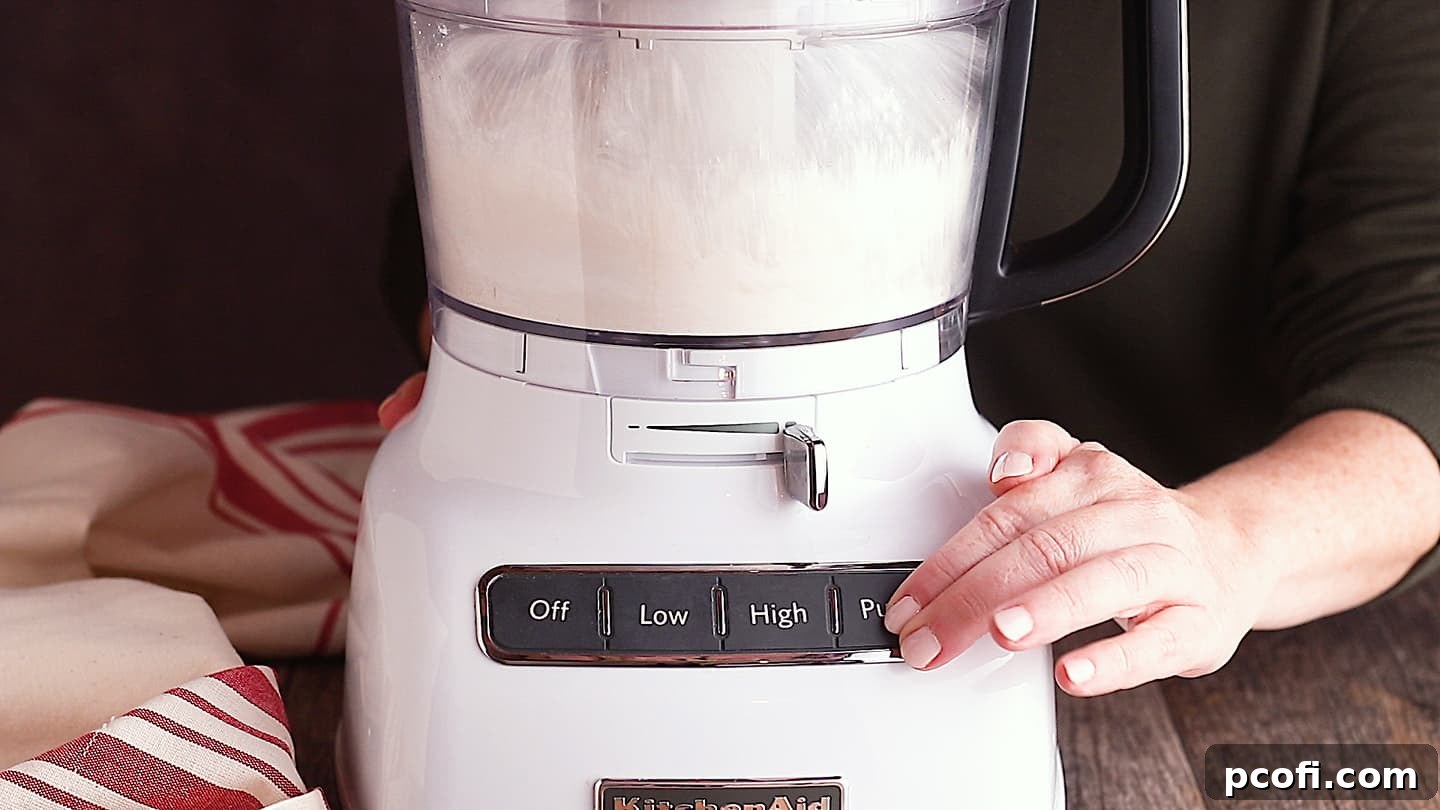 Apple dumpling dry ingredients in a food processor, a crucial step for homemade pastry.