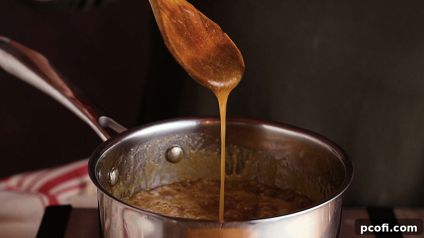 Thickened brown sugar sauce for apple dumplings, rich and bubbling with cinnamon aroma.