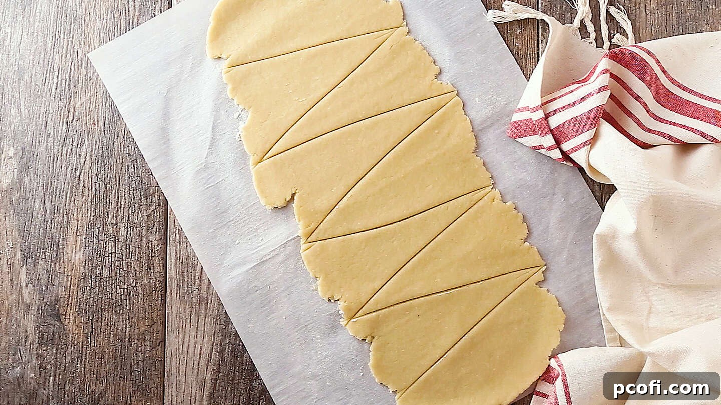 Cutting pastry into triangles for apple dumplings, ready for wrapping the apple filling.