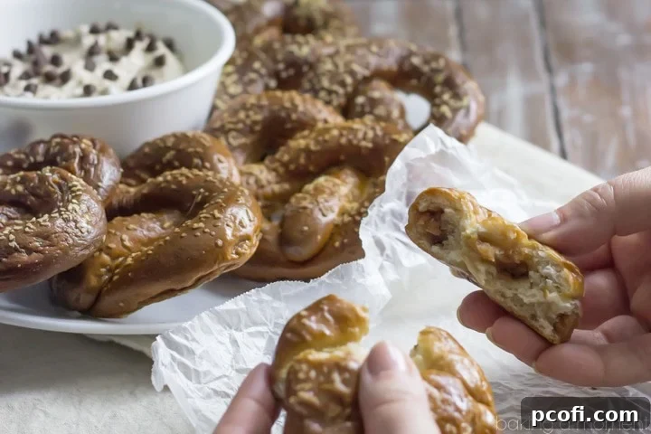 Homemade Soft Pretzels stuffed with Peanut Butter, served with a Malted Vanilla cream cheese Dip with Banana and Chocolate Chips. These Chubby Hubby Pretzels and Dip are totally outrageous! Perfect Superbowl dessert ;)