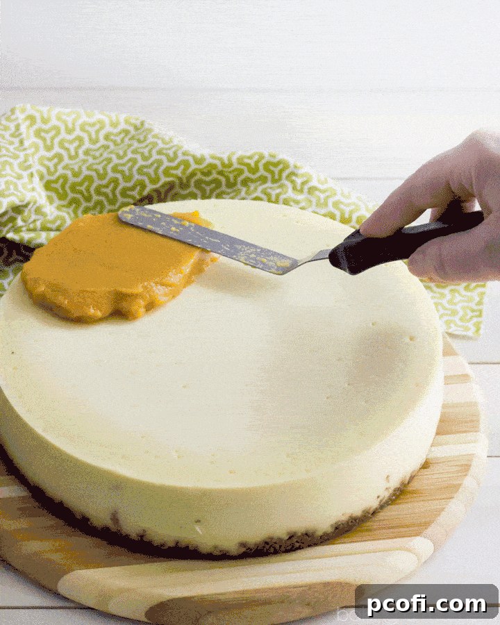 A slice of creamy New York style cheesecake on a gingersnap crust, generously topped with a sweet and seasonal persimmon topping and a dollop of whipped cream. A delightful dessert.