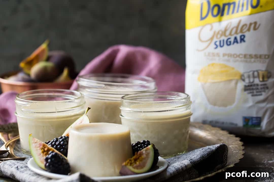 Panacota on a brass tray with golden sugar in the background.