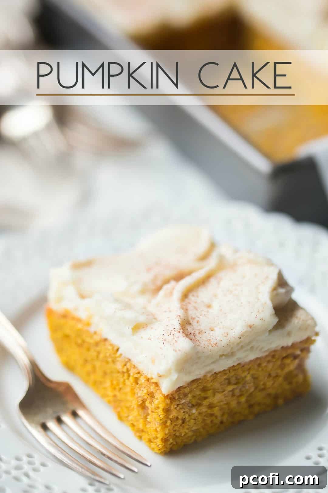 Square of pumpkin cake with cream cheese icing on a white plate, with a text overlay above that reads "Pumpkin Cake."