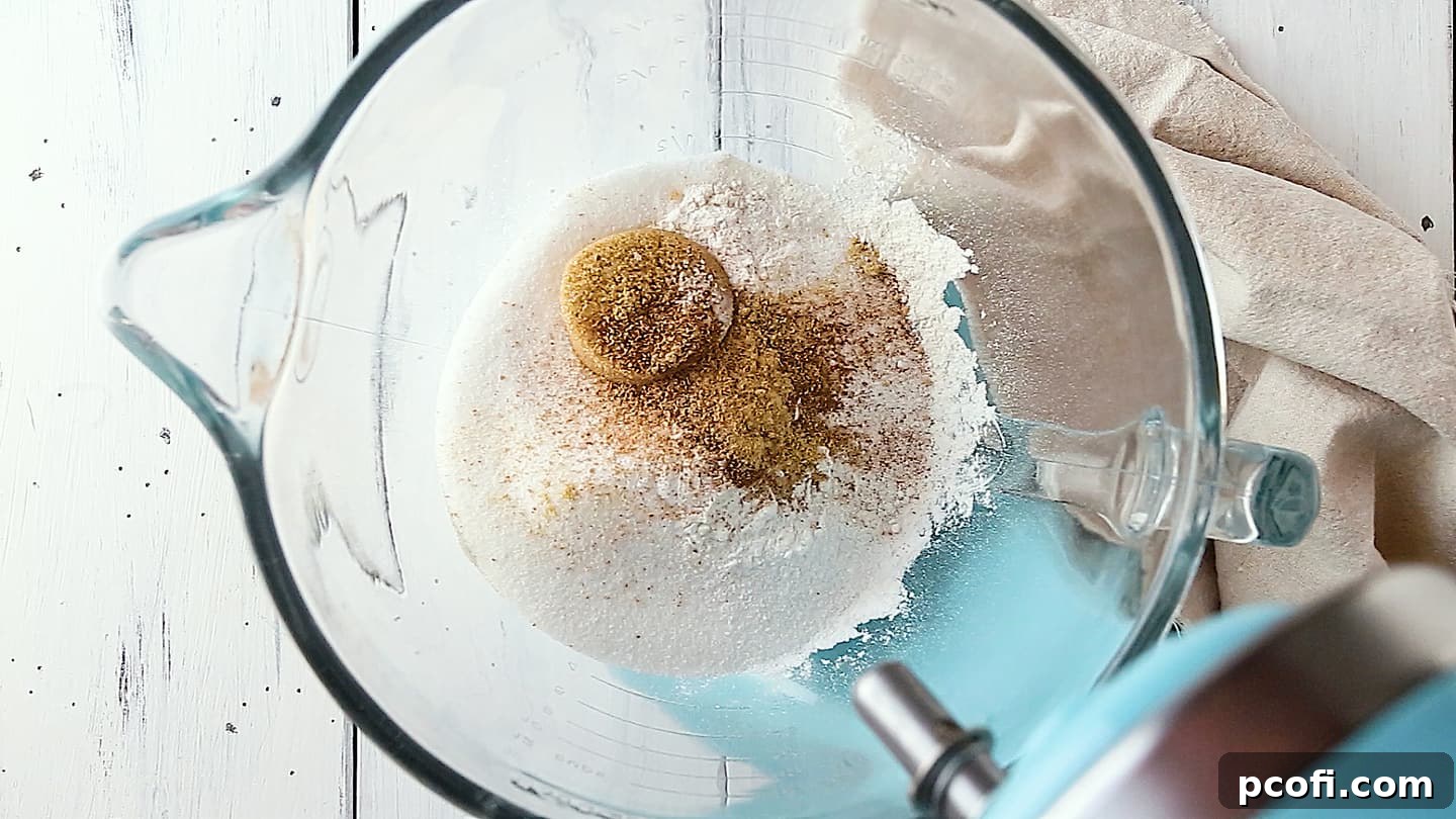 Dry ingredients for making pumpkin cake, in a large glass mixing bowl.