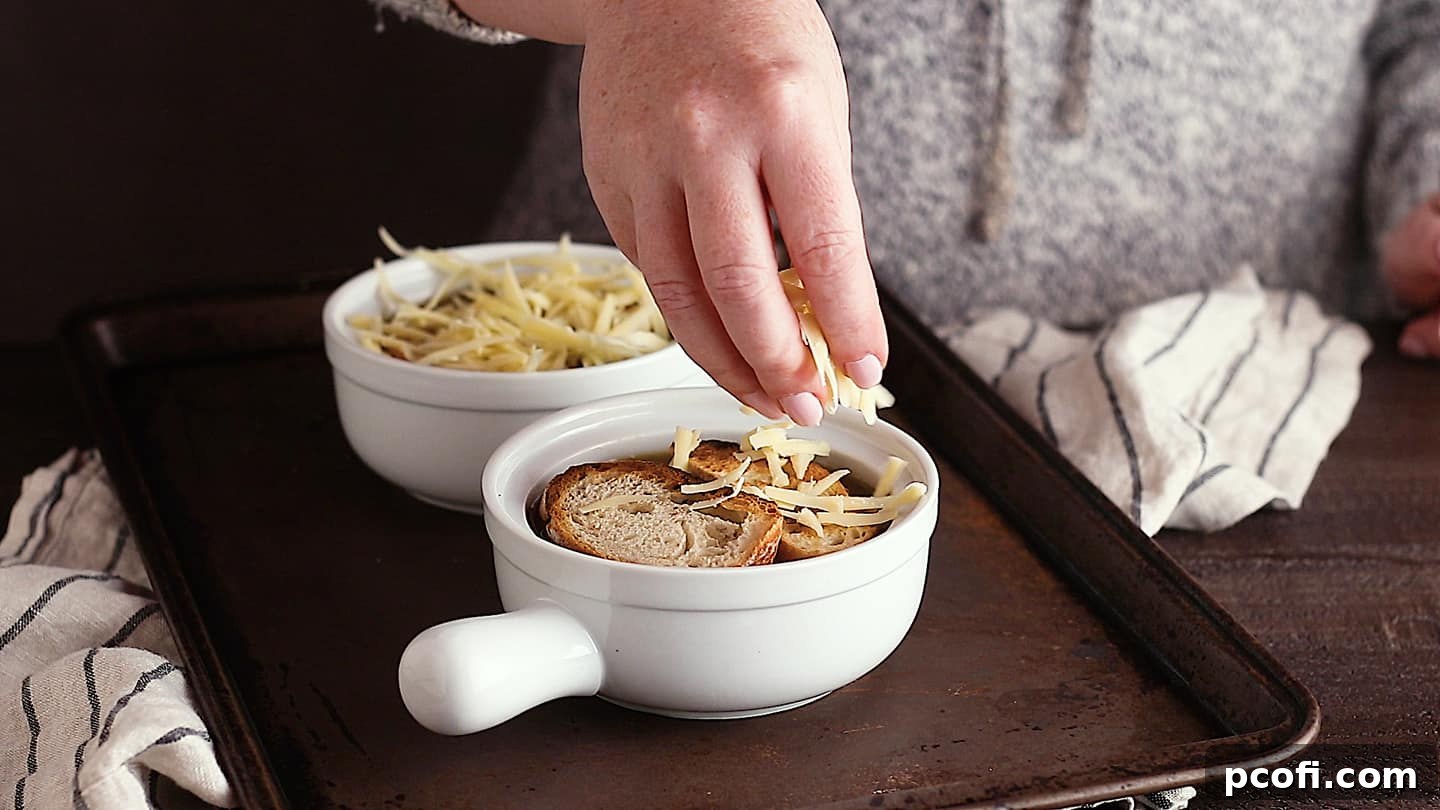 Topping French onion soup with cheese.