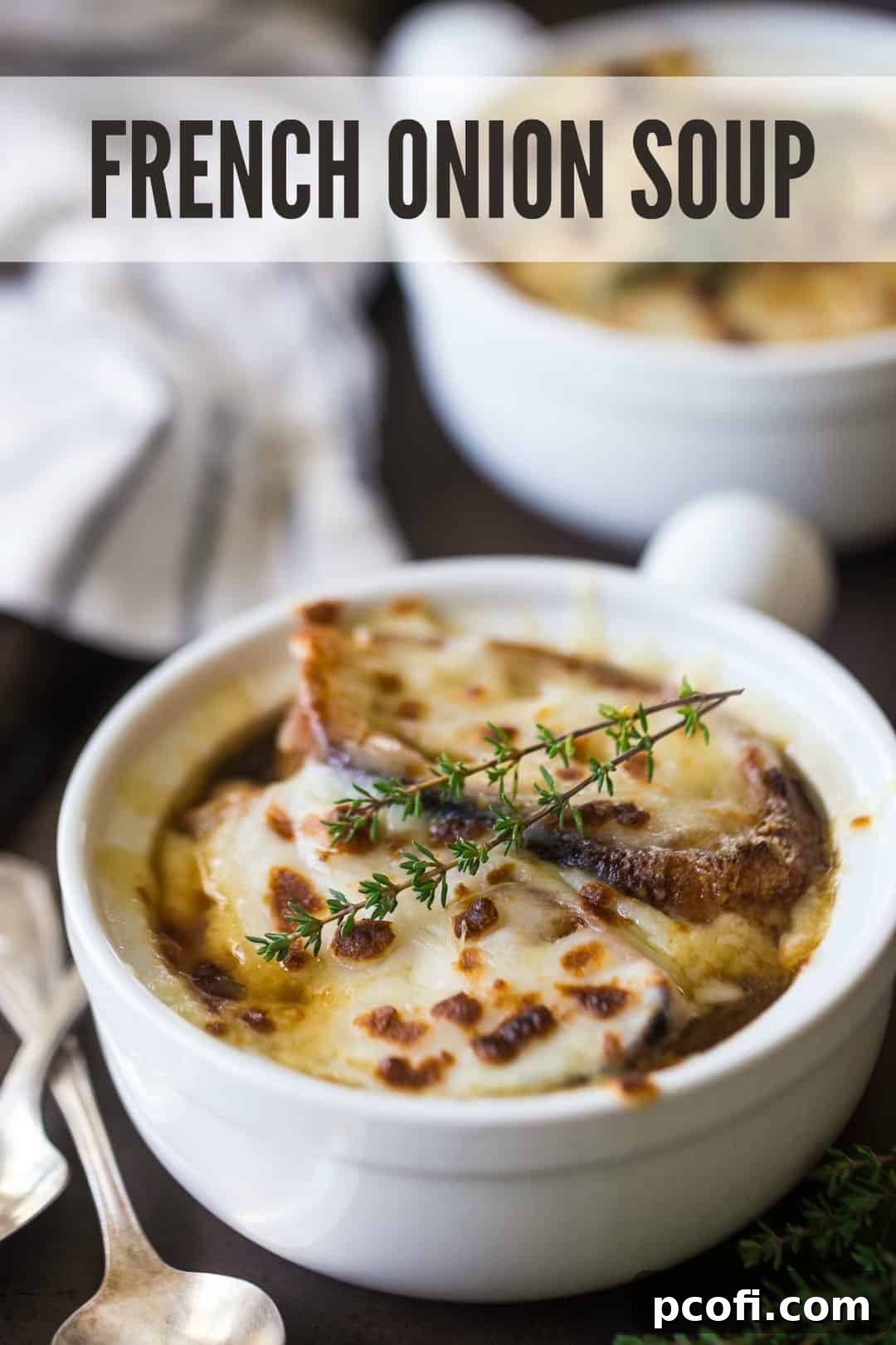 Homemade French onion soup recipe served in ceramic crocks, with melted cheese and fresh thyme, and a text overlay above reading "French Onion Soup."