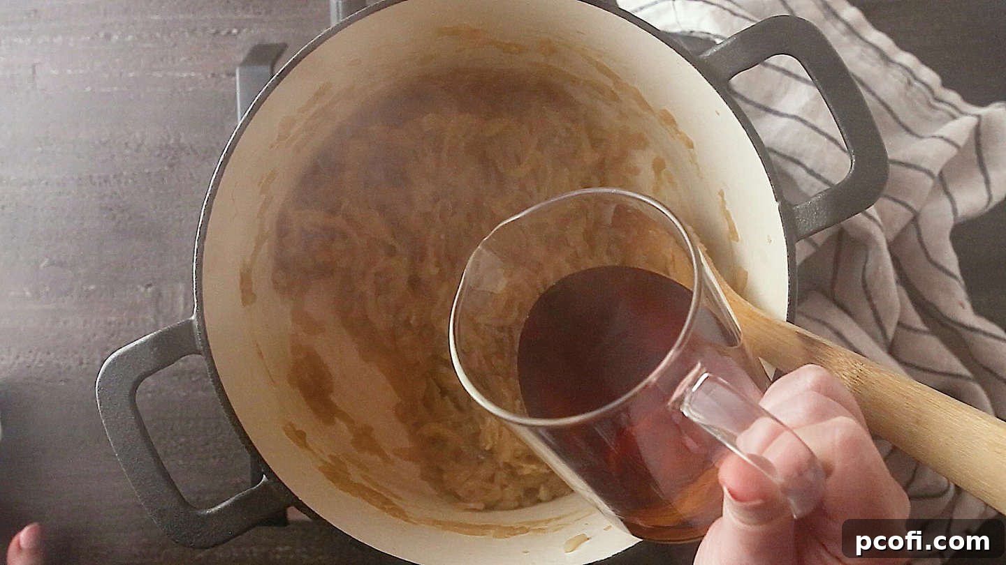 Adding wine to caramelized onions for French onion soup.