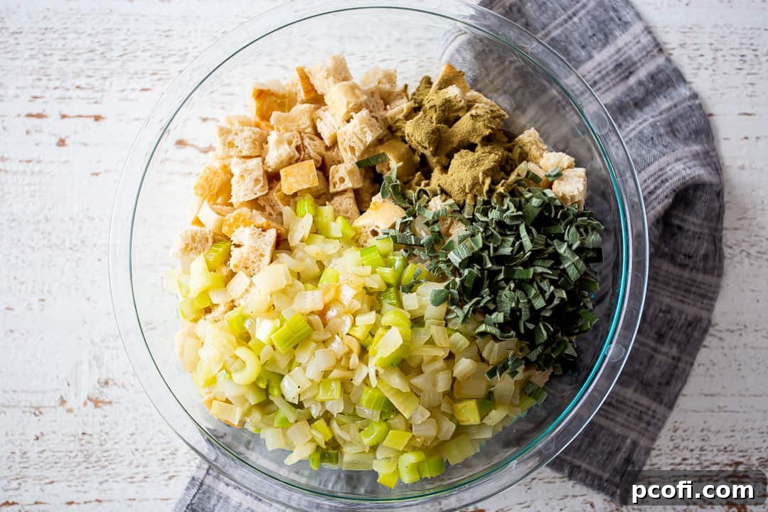 Ingredients for stuffing recipe in a large glass mixing bowl.