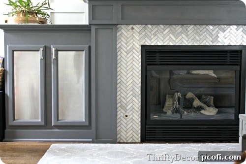 Fireplace surround tiled with elegant Carrera marble as home decor inspiration