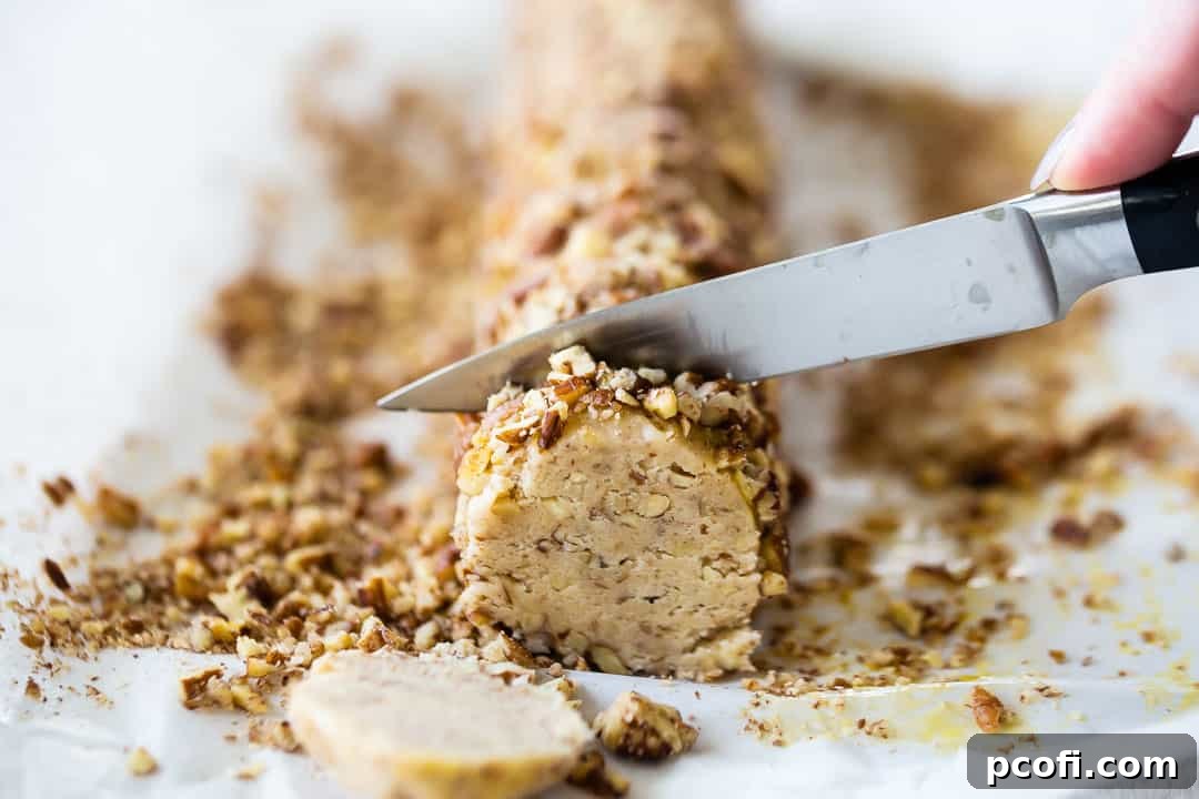 Precisely slicing the pecan-coated dough logs into uniform rounds, ready to be baked into perfect pecan sandies.