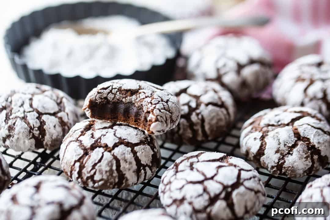 Chocolate crinkle cookies from scratch cooling on a wire rack after baking.