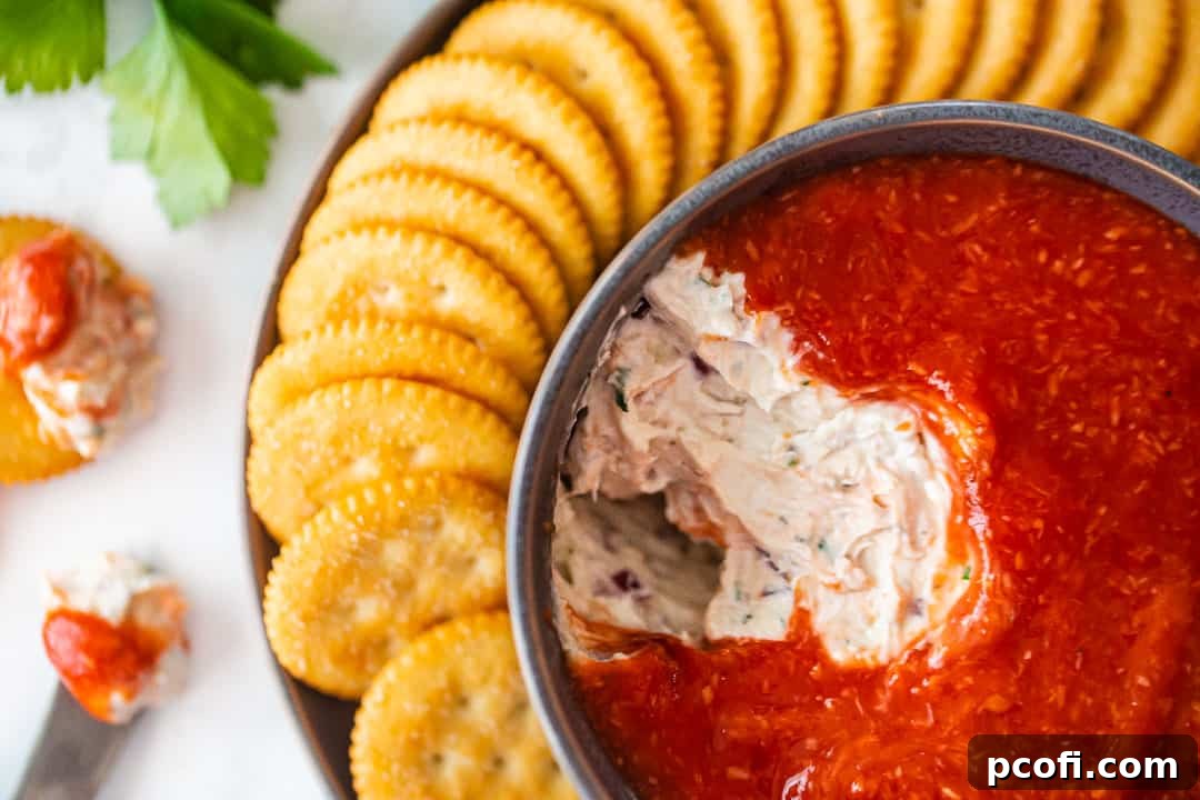 Easy crab dip recipe, prepared and served in a bowl with Ritz crackers.