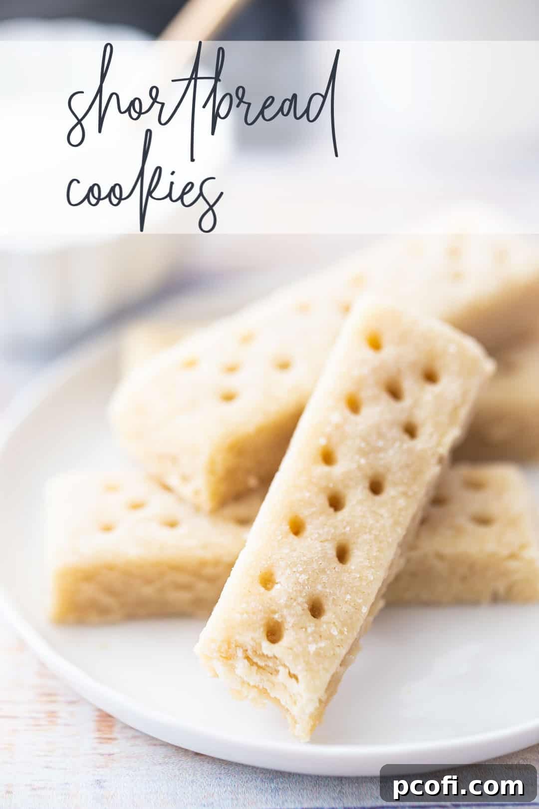 A close-up of beautifully baked shortbread cookies on a white plate, with the words 'Shortbread Cookies' overlaid above.