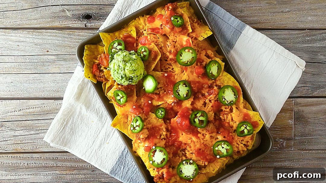 Sheet pan nachos with a dollop of homemade guacamole.