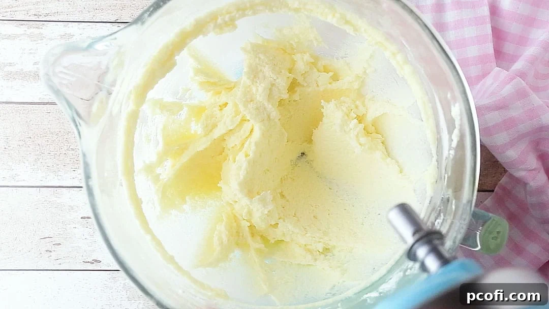 Creaming butter, cream cheese, and sugar together for thumbprint cookies.