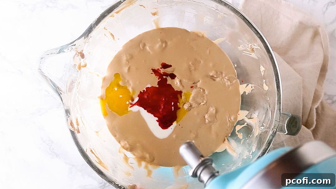 Red velvet cheesecake batter with buttermilk and vinegar.