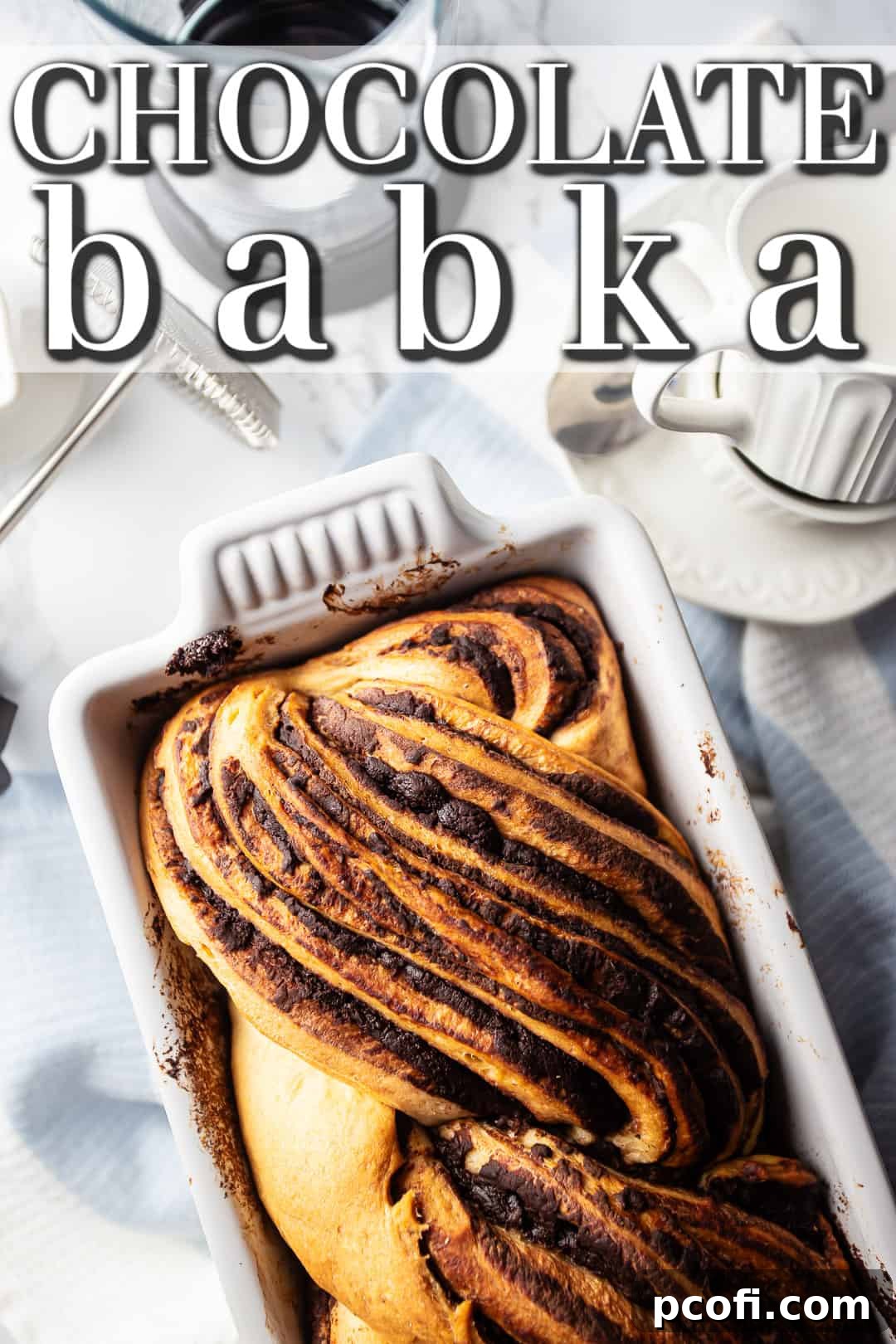 Chocolate babka recipe, baked in a white stoneware loaf pan.
