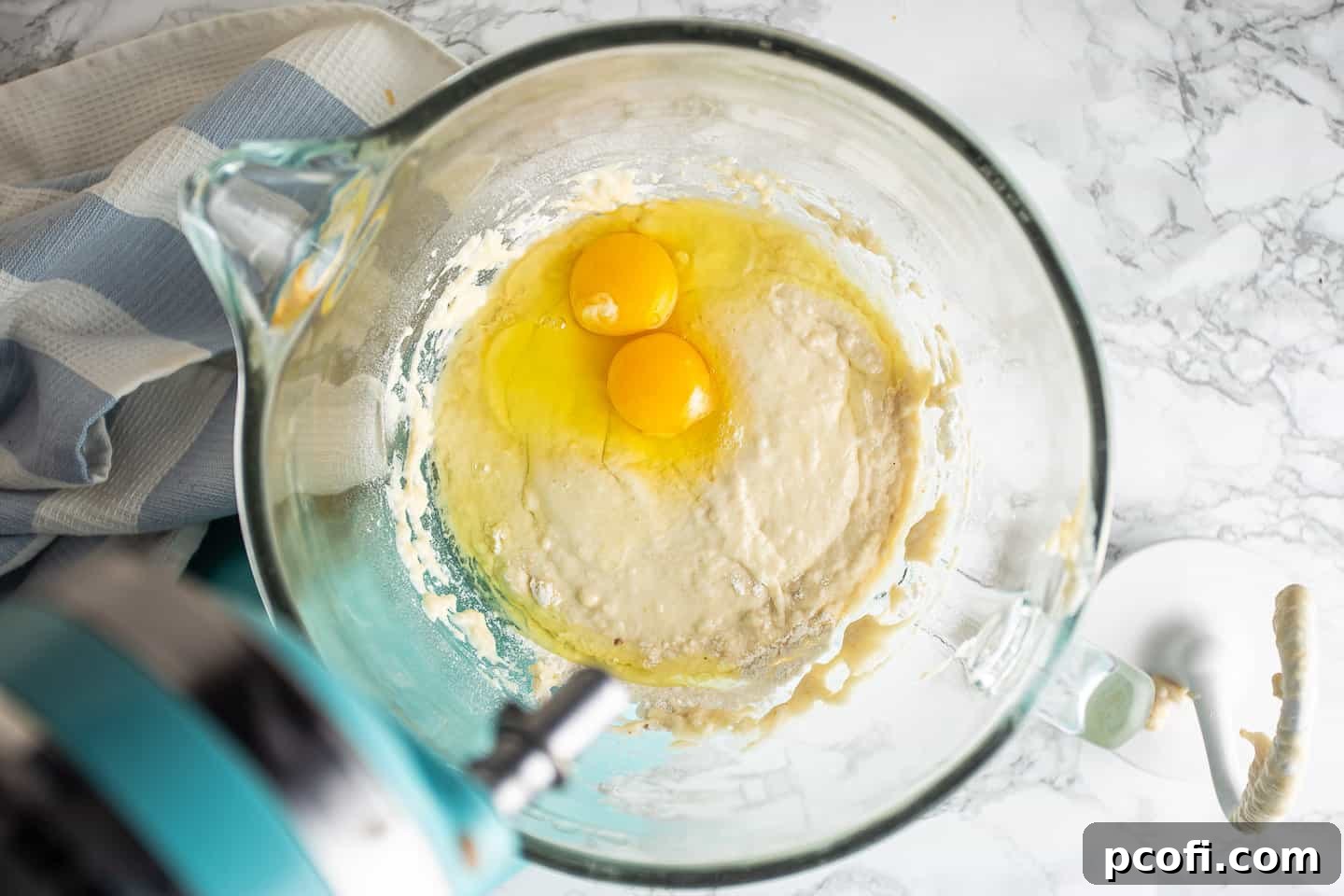 Adding eggs to babka dough.