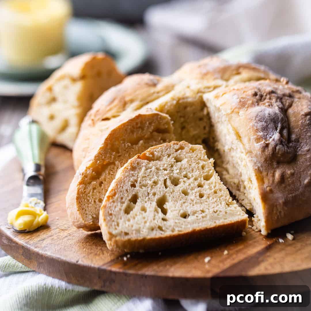 Irish soda bread, sliced and served on a wooden board.