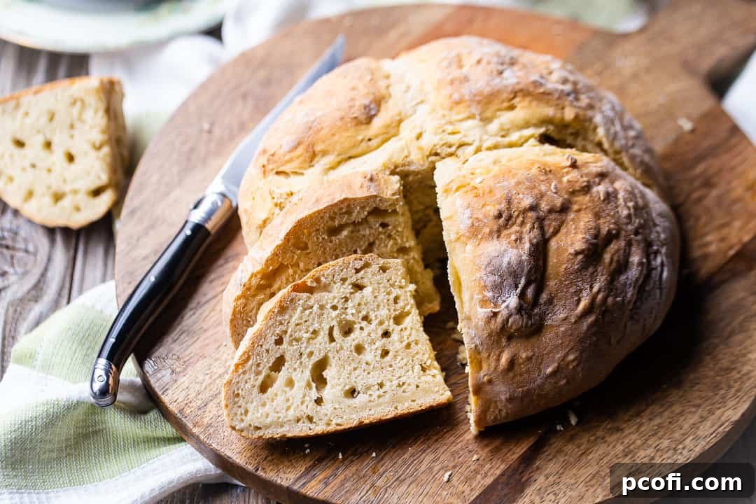 Irish soda bread recipe from Ireland, served on a wooden board with a black-handled knife.