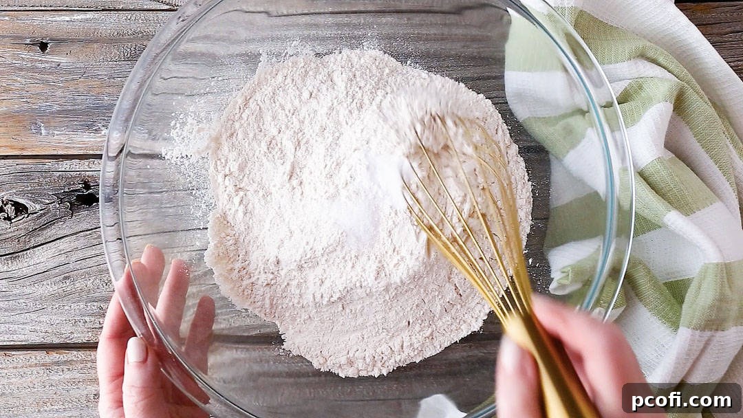 Dry ingredients for making Irish soda bread, in a large glass mixing bowl.