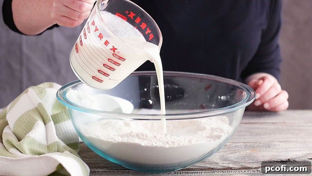 Adding buttermilk to soda bread.