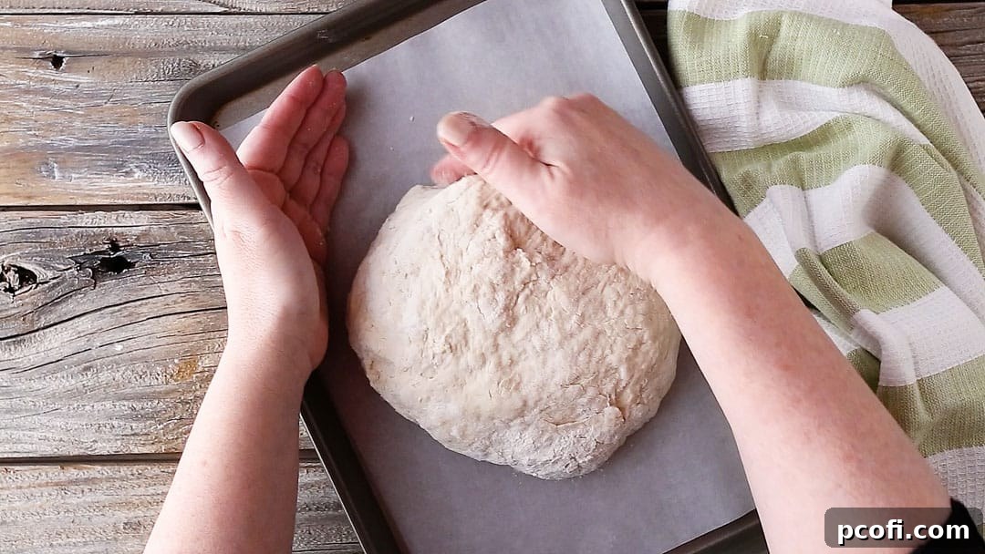 Shaping Irish soda bread into a round loaf.