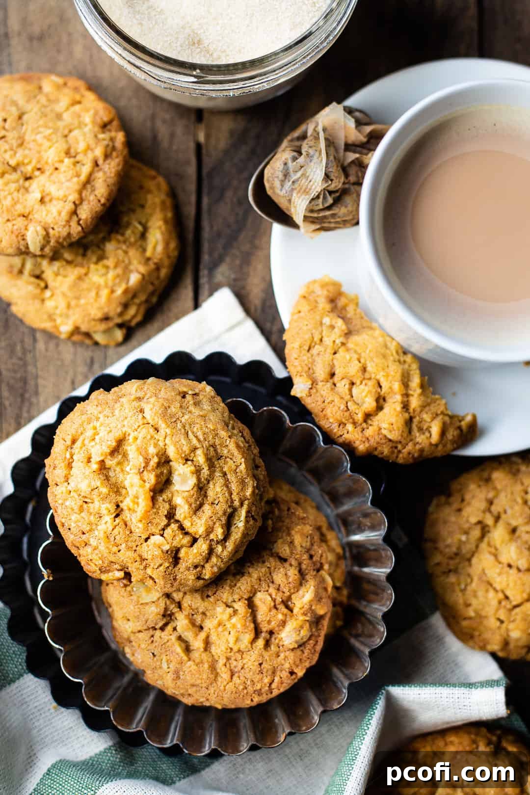 Overhead image of Irish oat cookies, arranged on a dark wood table with a green striped cloth.