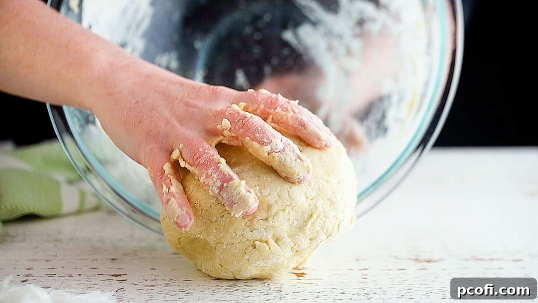 Transferring sticky Irish scone dough to a lightly floured work surface.