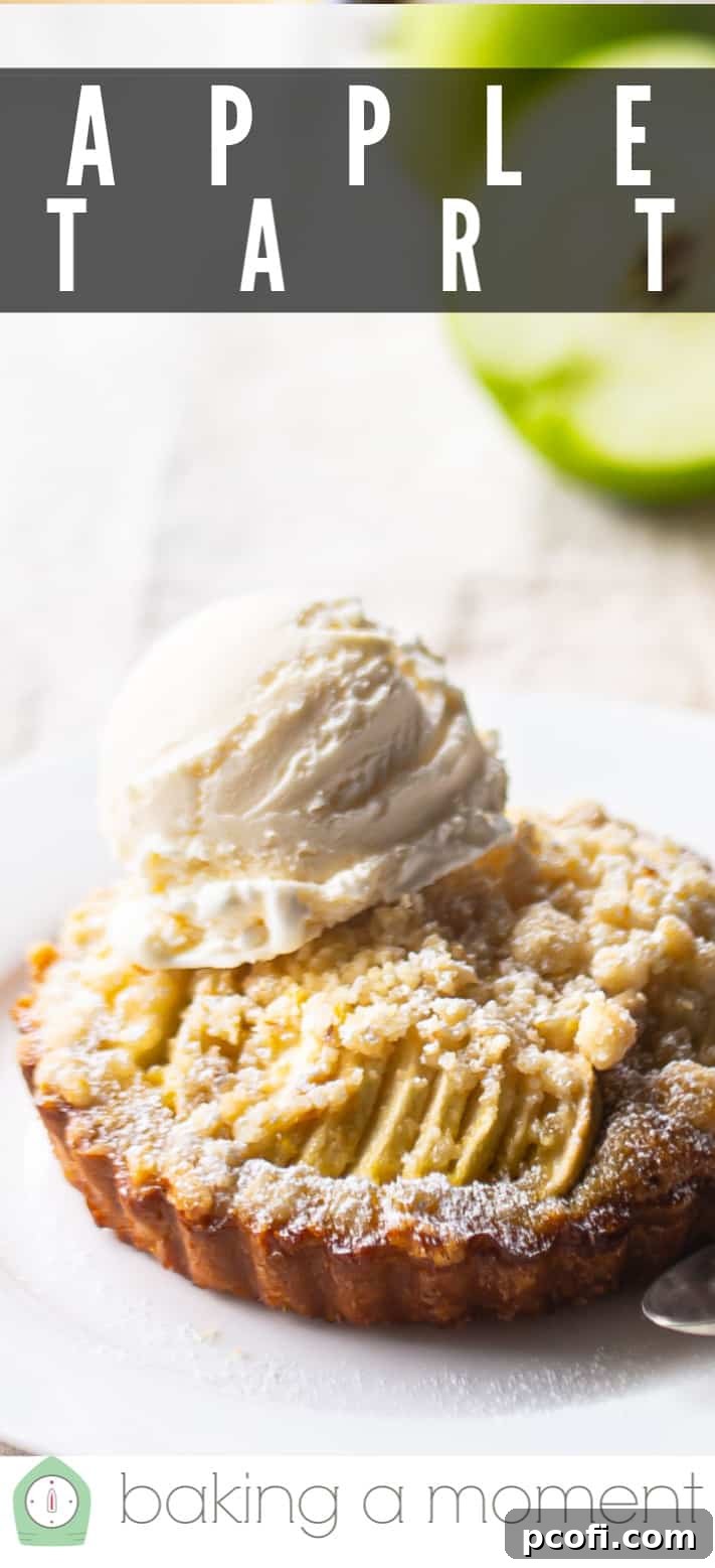 Closeup image of an apple tart, with vibrant green apples blurred in the background, emphasizing fresh ingredients.