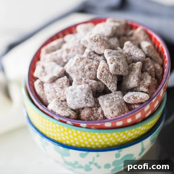 A generous serving of Muddy Buddies, also known as Puppy Chow, a delightful chocolate peanut butter cereal mix, perfect for snacking.