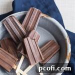 Homemade fudge pops, perfectly frozen and ready for a refreshing treat, showcasing their rich, dark color.