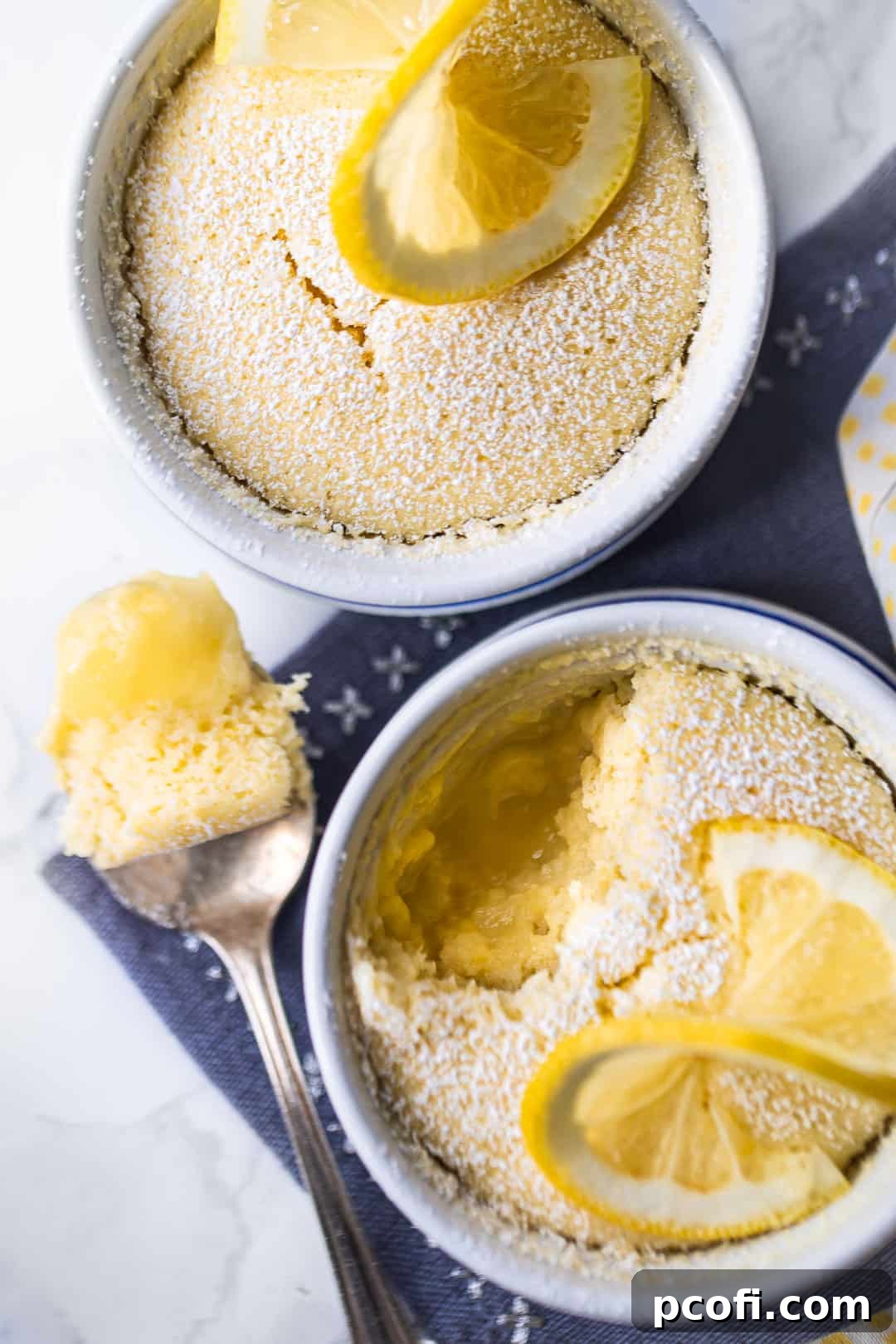 Best lemon pudding cake recipe, served in ramekins with powdered sugar on top.