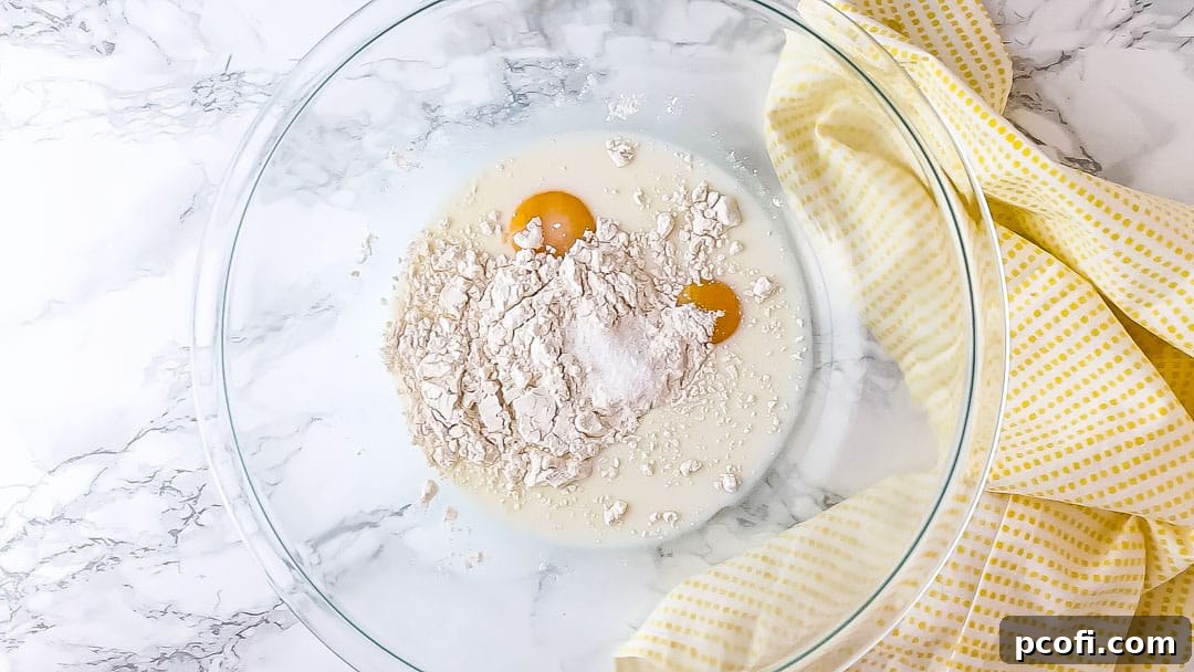 Lemon pudding cake ingredients in a large mixing bowl, ready to be combined.