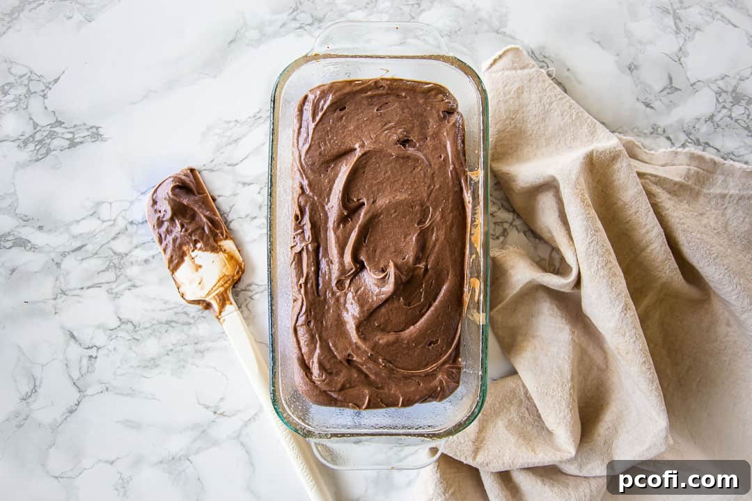 Chocolate pound cake batter in a loaf pan.