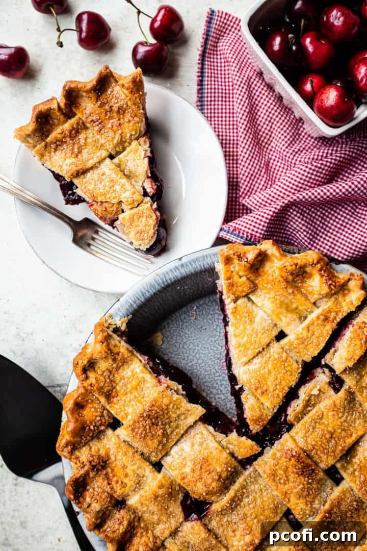 A freshly baked homemade cherry pie, showcasing a beautifully golden lattice crust and a vibrant, bubbling cherry filling, a true culinary delight.