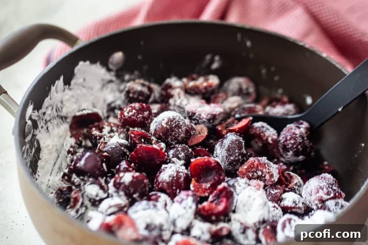 The process of making cherry pie filling, showing fresh cherries coated in sugar, cornstarch, lemon juice, and salt, ready for cooking.