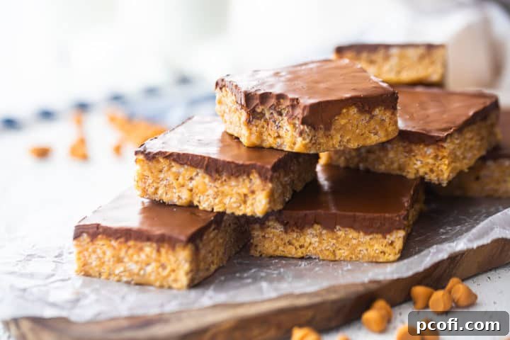 Scotcheroo bars served on a board with glasses of milk in the background, inviting a delicious treat.