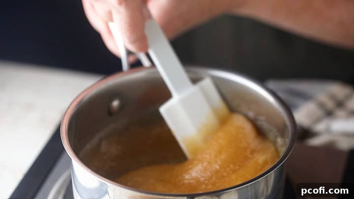 Heating sugar and honey together in a small pot, showing the initial mixing stage.