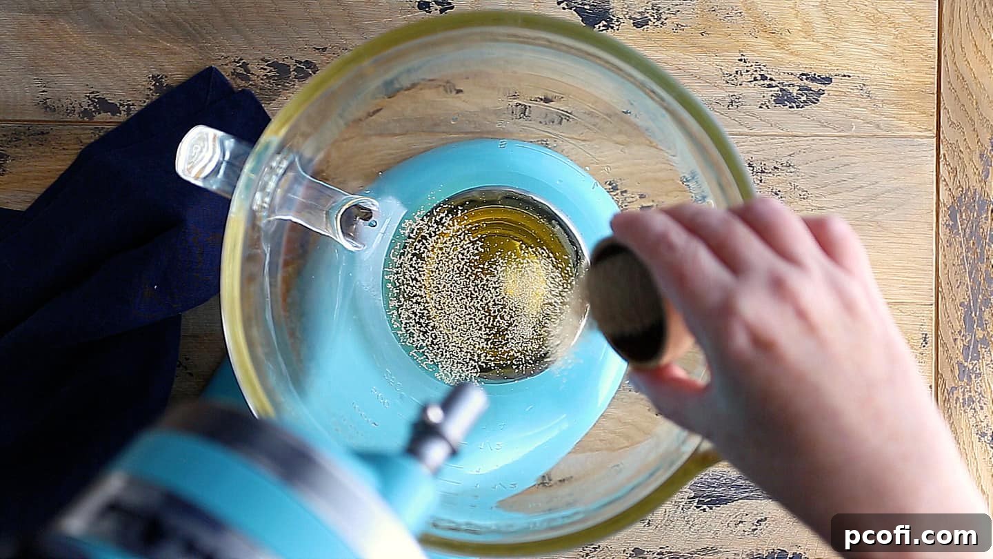 Sprinkling yeast over sweetened water.