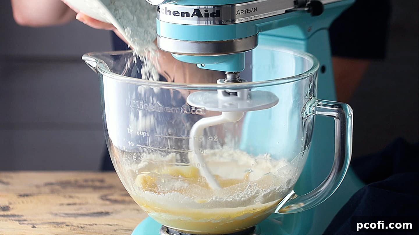Adding flour to challah dough.