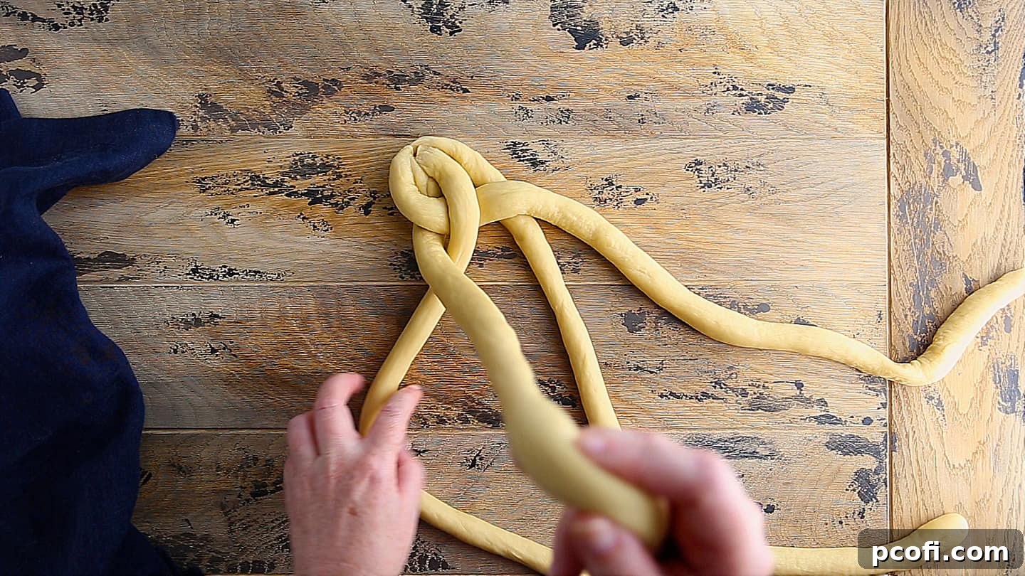 Creating a 4-strand braid with challah dough.