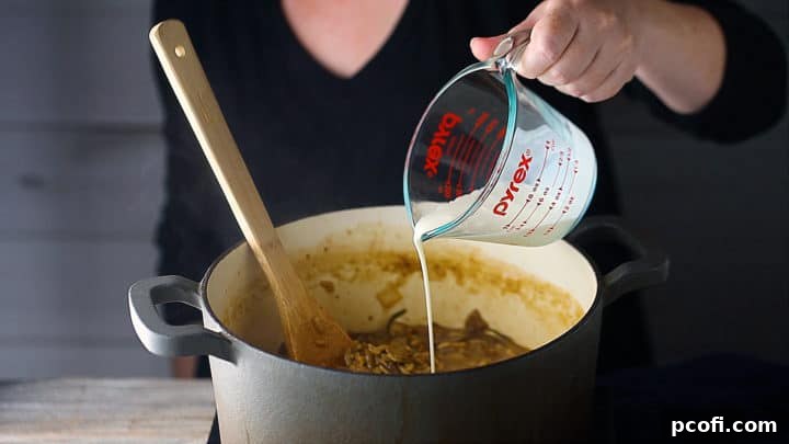 Adding cream to mushroom risotto.